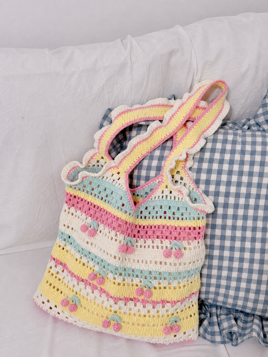 Pastel cherry crochet tote bag with soft yarn texture and handmade details