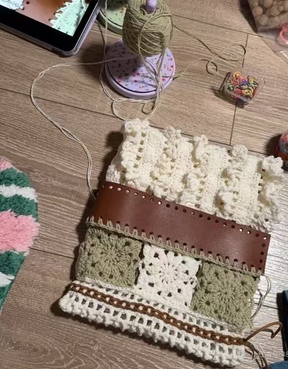 Crochet patchwork bag work in progress with sage green and cream yarn