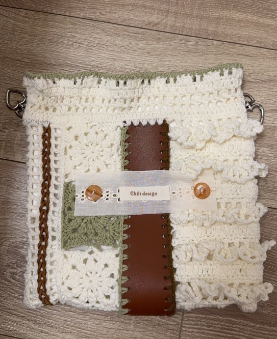 Leather trim and drawstring detail on a handmade crochet bag