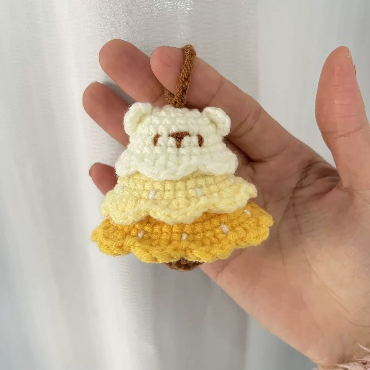 Handmade crochet charm detail with layered yarn stitches