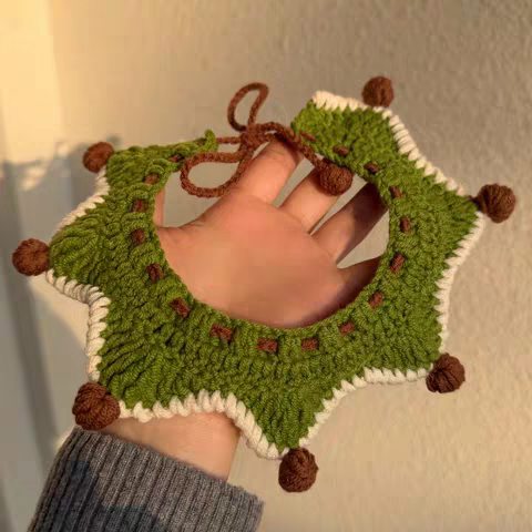 Green crochet pet collar scarf flat lay